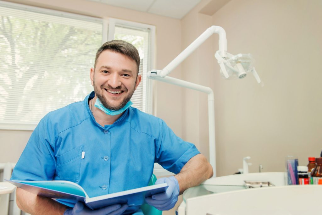 Portrait of smiling dentist in the dental office